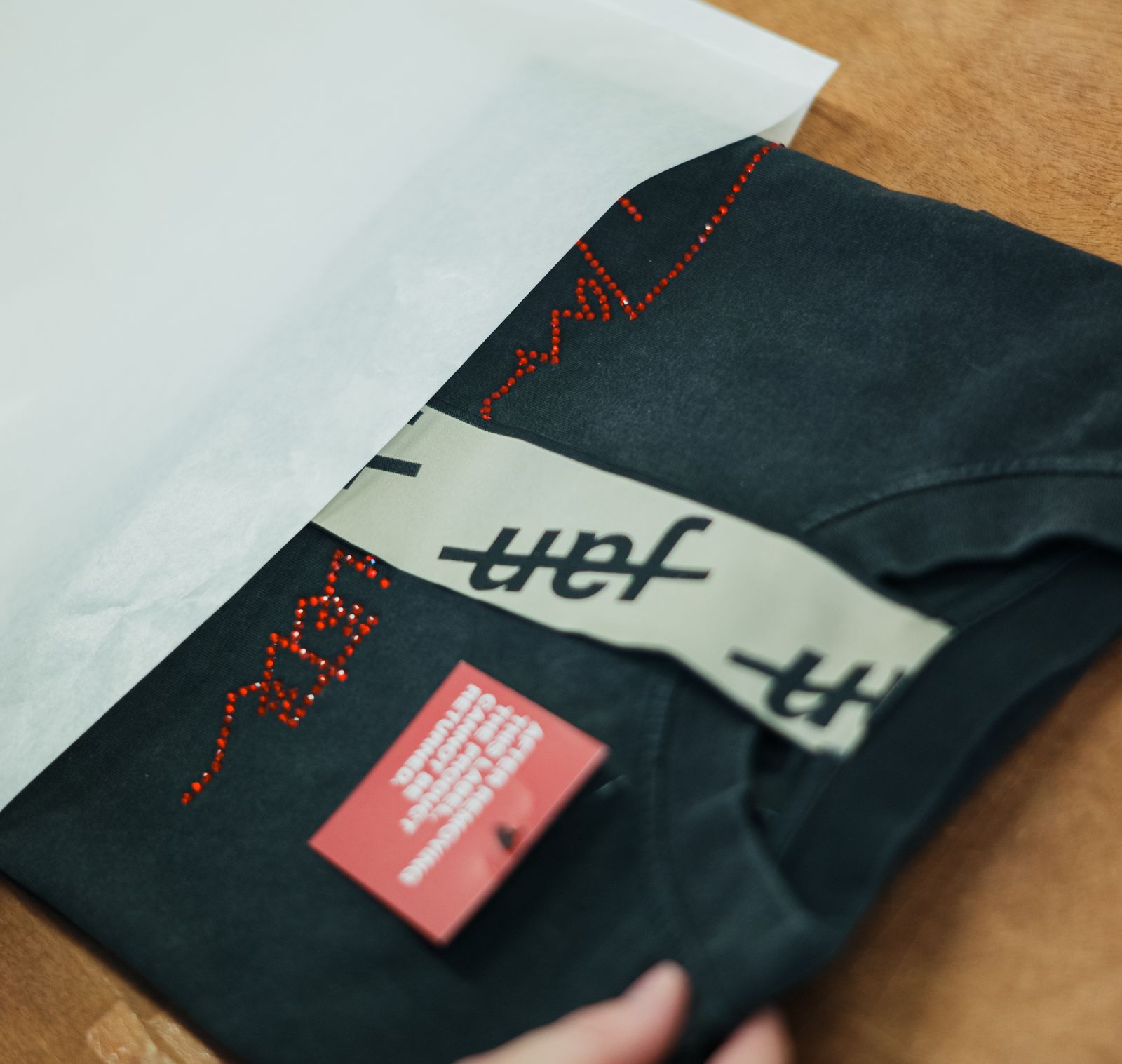 Jan Société parcel: T-shirt with a hangtag and card in tissue paper